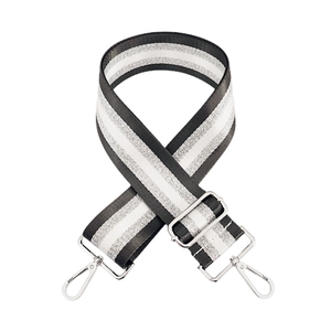 Macro view of adjustable woven strap featuring silver glitter stripes and metal lobster clasps