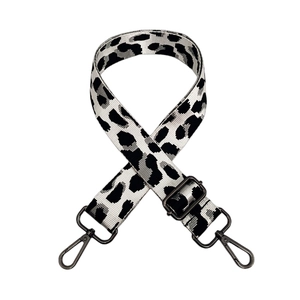 Detailed view of adjustable leopard print bag strap with dark grey metal lobster clasps