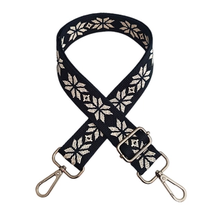Detail of colorful ethnic embroidery strap with silver metal lobster clasps and buckles