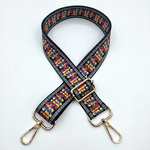 Close-up of adjustable colorful ethnic pattern shoulder strap with gold metal buckles
