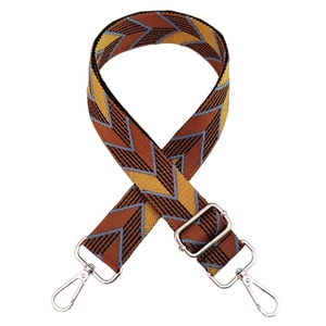 Macro detail of thick woven purse strap with colorful geometric arrow pattern and silver hooks