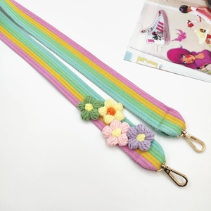 Detail of colorful crochet flower bag strap with rainbow stripes and gold lobster clasp