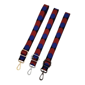 Adjustable woven purse strap with red blue pattern and various metal clasps