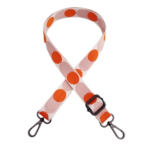 Adjustable colorful polka dot bag strap with black metal lobster clasps and woven texture