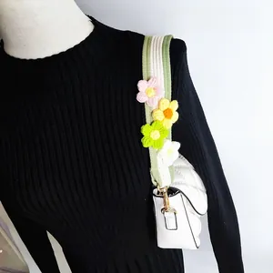 Detail of short leather armpit bag with colorful 3D crochet flowers on wide strap