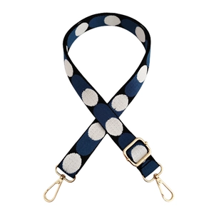 Close-up of a 2.5cm navy blue polka dot replacement strap with gold metal hardware