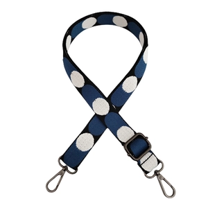 Detail of adjustable blue strap with white polka dots and dark gunmetal metal hooks