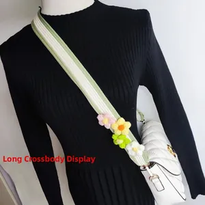 Close-up of hand-knitted floral shoulder strap with colorful crochet flowers for crossbody bags