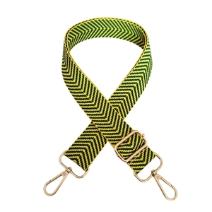 Macro shot of colorful herringbone fabric strap with golden metal lobster clasps