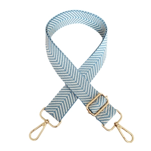 Detail of blue and white herringbone wide bag strap with gold metal lobster clasps