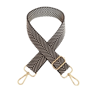 Detail of adjustable black and white chevron woven strap with gold lobster clasps