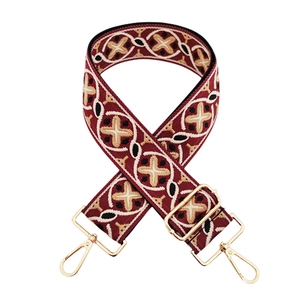 Close-up of ethnic style embroidered replacement bag strap with geometric patterns and gold hooks