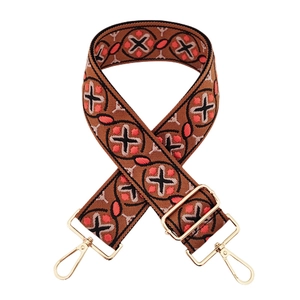 Detail of bohemian embroidered bag strap with golden metal hooks and geometric patterns