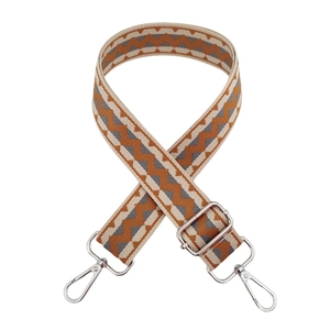 Detail of adjustable 3.8cm wide bag strap with colorful woven wave patterns and silver metal clips