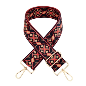 Close-up of ethnic geometric embroidery on replacement strap with gold swivel hooks