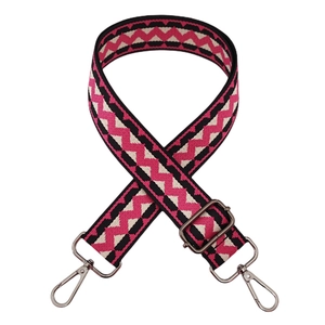 Detail of 3.8cm wide strap with black, white, and pink wavy geometric pattern and silver hooks