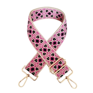 Close-up of colorful geometric jacquard bag strap with gold metal lobster clasps