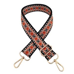 Detail of colorful geometric jacquard bag strap with gold metal lobster clasps