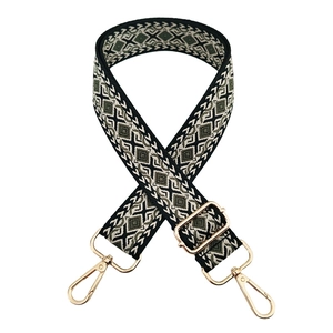 Detail of adjustable geometric ethnic style woven bag strap with gold lobster clasps