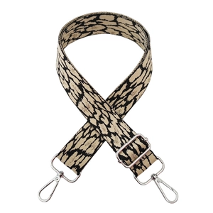 Detail of leopard print wide bag strap with silver metal lobster clasps and slider buckle