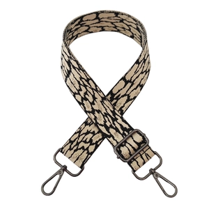 Close-up of leopard pattern fabric strap with black metal hooks and adjustment buckle