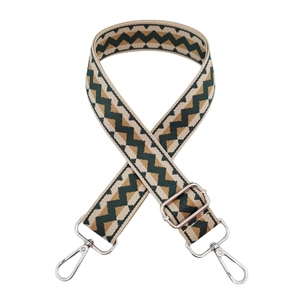 Close-up of adjustable woven shoulder strap with wave pattern and silver metal swivel hooks