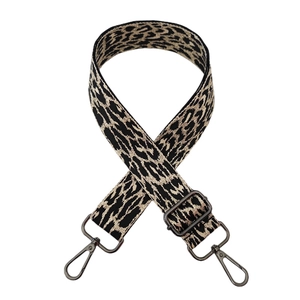Detail of adjustable leopard print bag strap with gunmetal swivel hooks and thick weaving