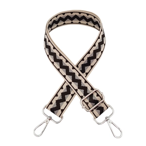 Detail of adjustable woven bag strap with beige and grey wave pattern and silver metal clasp