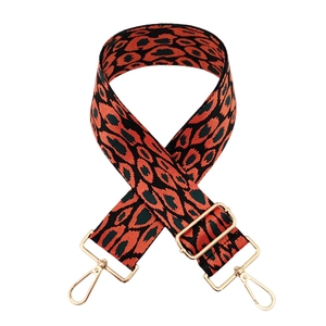 Close-up of jacquard leopard strap with golden metal hooks and adjustable buckle