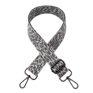 Detail of leopard print wide strap with dark grey metal lobster clasps and buckle