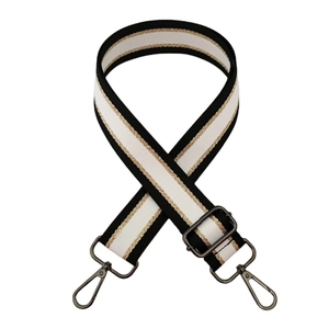 Detail of adjustable leopard print bag strap with gold trim and gray metal hooks