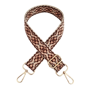 Close-up of jacquard woven strap with geometric patterns and golden metal buckles