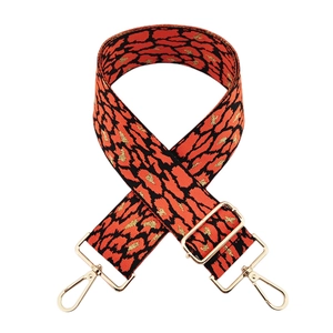 Detail of leopard print bag strap with golden hardware and adjustable buckle