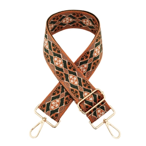 Detail eines böhmischen Taschengurts mit orangefarbenem Jacquardmuster und Goldhaken