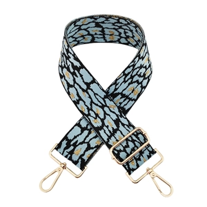 Detail of light blue leopard print woven bag strap with golden metallic thread and hooks
