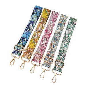 Five assorted ethnic floral adjustable canvas shoulder straps with gold metal hardware