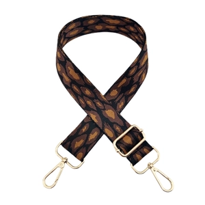 Detailed view of leopard print jacquard strap with polished gold-tone metal hooks