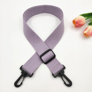 Close-up of adjustable light purple woven strap with black plastic swivel hooks and buckle