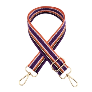 Detail of vintage striped purple shoulder strap with golden metal swivel hooks