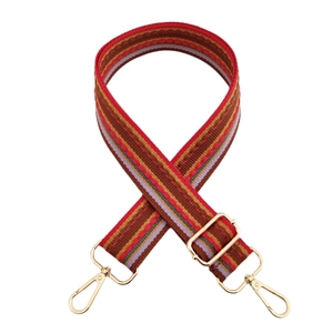 Close-up of retro striped woven bag strap with polished gold-tone lobster clasps