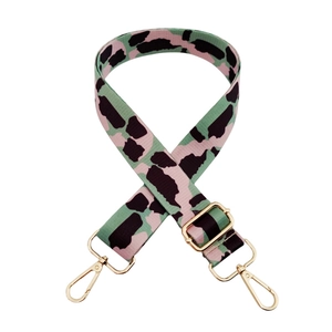 Adjustable colorful leopard print bag strap with gold metal buckles on white background