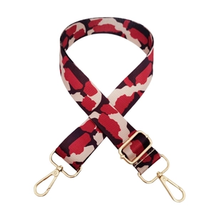 Adjustable wide replacement bag strap with red, black and beige pattern and gold hardware