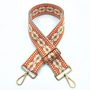 Detail of adjustable geometric ethnic style woven strap with golden metal lobster clasps