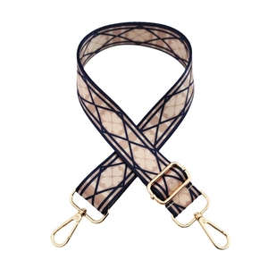 Detail of bohemian geometric woven shoulder strap with gold-plated metal lobster clasps