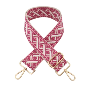 Detail of colorful jacquard wide bag strap with ethnic diamond patterns and gold buckles