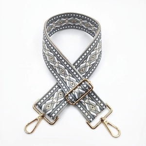 Detail of adjustable 5cm geometric jacquard strap with gold-tone metal lobster clasps