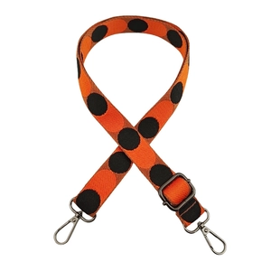 Detail of 2.5cm orange polka dot nylon shoulder strap with gunmetal swivel hooks
