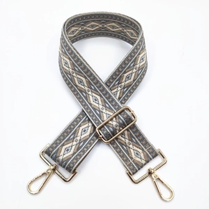 Detail of 5cm ethnic jacquard wide strap with golden metal lobster clasps and buckle