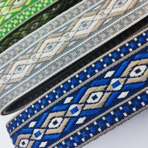 Detailed close-up showing woven texture and geometric folk patterns of adjustable straps