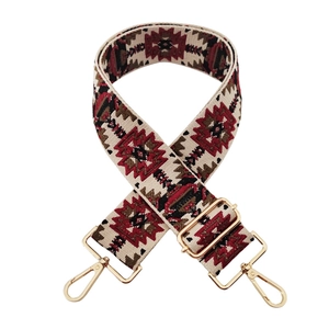 Close-up of bohemian geometric jacquard bag strap with adjustable light gold metal buckles